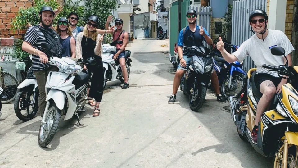 Travellers smiling on scooters rented from Motorbike Dalat