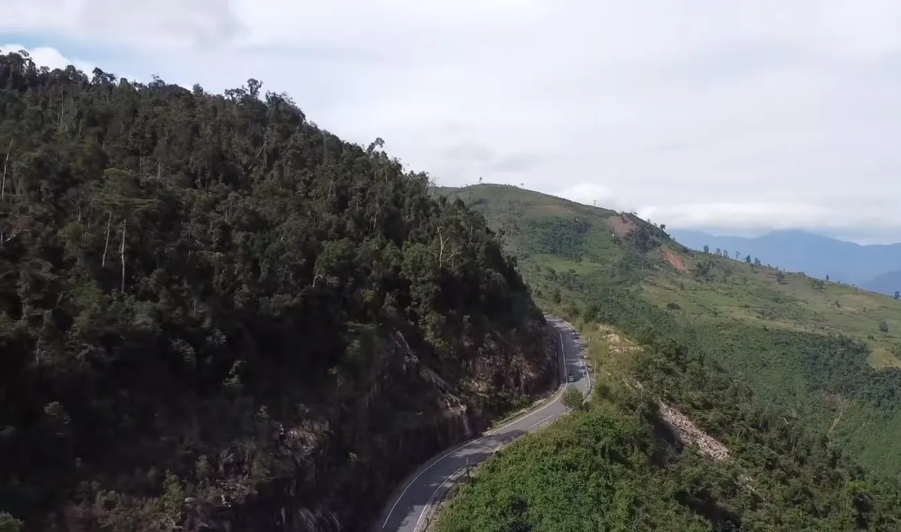 A motorbike road winding up a mountain pass in the Vietnamese highlands